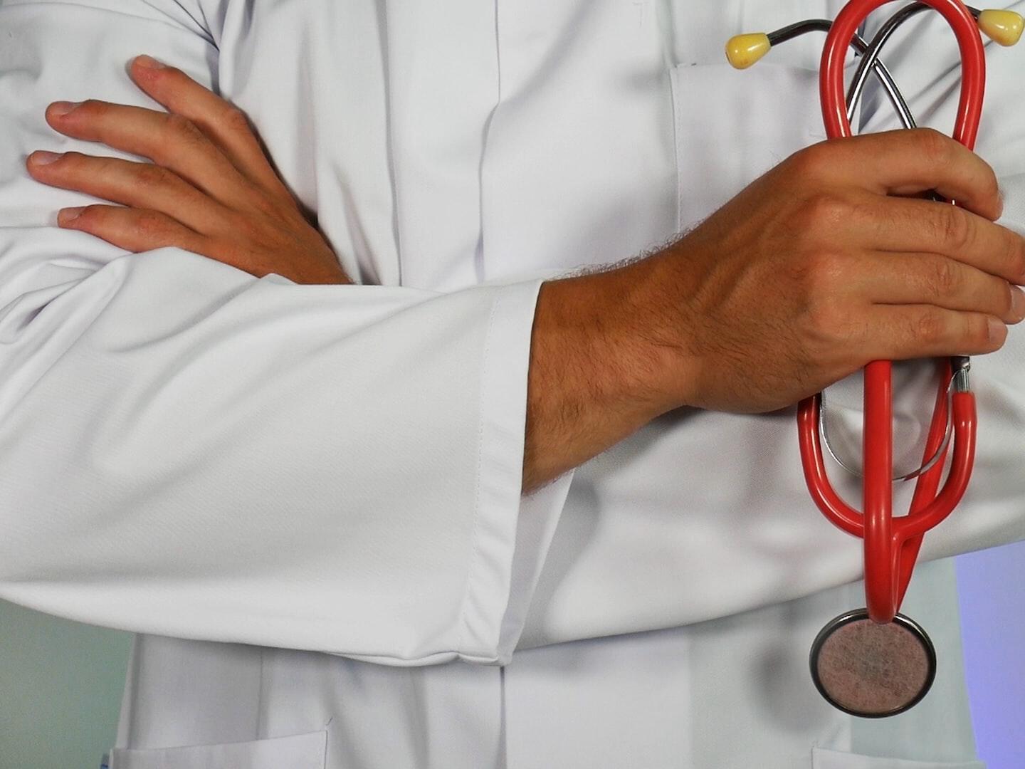 doctor holding red stethoscope